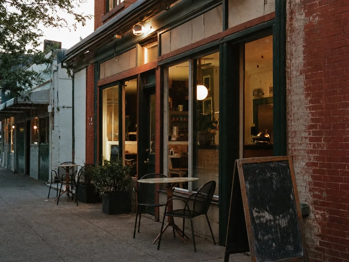 Independent neighborhood restaurant storefront at dusk