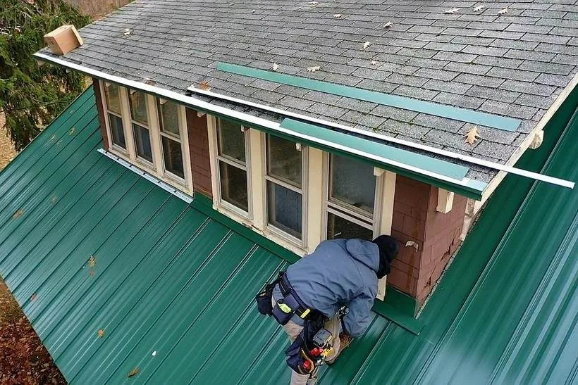 Roofing crew installing panels on a residential roof