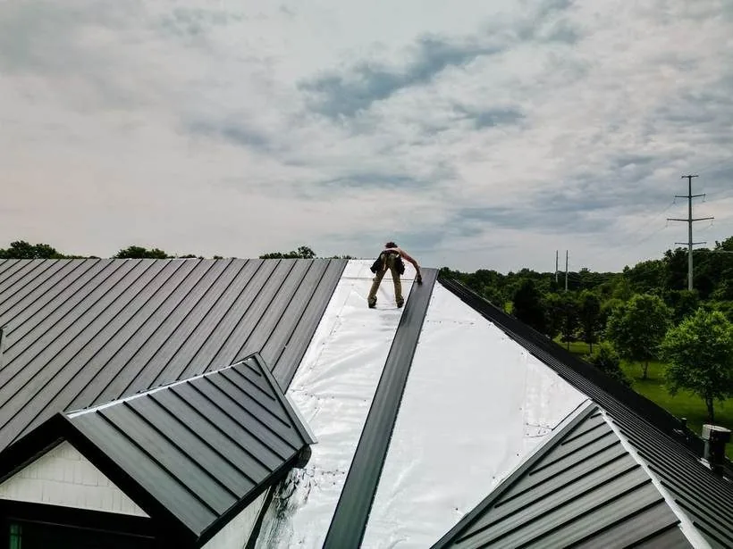Crew working on a metal roof installation